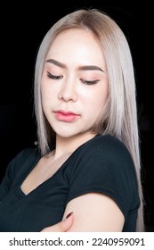 head shot of caucasian beauty girl ashen hair wear black t shirt with studio lighting for cosmatic black background - Shutterstock ID 2240959091