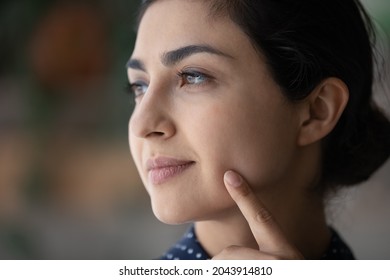 Head Shot Close Up Attractive Millennial Indian Woman With Natural Makeup Pointing Finger To Her Cheek, Beautiful Young Female Showing Healthy Perfect Smooth Face Skin, Skincare And Beauty Concept