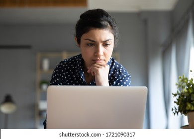 Head shot close up concentrated young indian woman looking at laptop monitor. Focused millennial hindu ethnic businesswoman freelancer solving problem. communicating with client customer online. - Shutterstock ID 1721090317