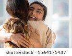 Head shot close up happy multiracial girl cuddling smiling indian female friend. Overjoyed excited best buddies emracing hugging greeting each other with success true strong friendship concept.