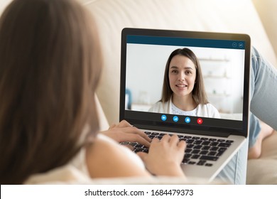 Head shot close up pc screen view attractive young woman chatting with female friend sister online, using videoconference computer application, distant internet communication preventing virus spread. - Shutterstock ID 1684479373