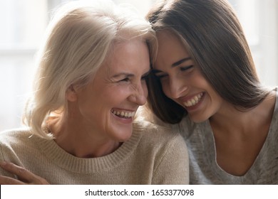 Head Shot Close Up Portrait Happy Smiling Mature Mother And Grown Up Adult Daughter Bonding, Touching Foreheads, Laughing, Having Fun Together, Enjoying Free Time Together, Two Generations Relations.