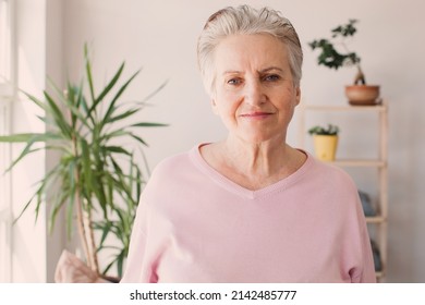 Head shot close up portrait happy healthy mature woman at home. Smiling pleasant 60s elderly mother looking at camera, posing for photo in modern living room. - Shutterstock ID 2142485777