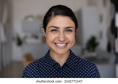 Head Shot Close Up Portrait Of Happy Young Indian Woman Showing White Smile With Straight Teeth, Feeling Confident At Home Office. Sincere Female Client Satisfied With Professional Orthodontic Service