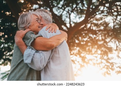 Head shot close up portrait happy grey haired middle aged woman snuggling to smiling older husband, enjoying tender moment at park. Bonding loving old family couple embracing, feeling happiness. - Powered by Shutterstock