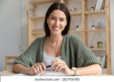 Head shot close up portrait smiling businesswoman talking, looking at camera, sitting at desk in office, confident friendly business coach mentor recording video, manager consulting client online - Shutterstock ID 1817936783