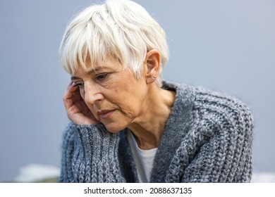 Head Shot Close Up Portrait Thoughtful Middle Aged Retired Woman Worrying About Personal Health Problems. Upset Older Female Retiree Thinking Of Family Troubles, Feeling Lonely, Sitting At Home.