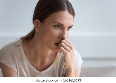 Head shot close up serious upset thoughtful young woman looking in distance, thinking about problems, pensive unhappy female making difficult decision, lost in thoughts, consider life troubles