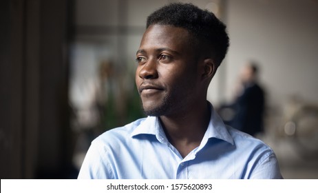Head shot close up young thoughtful african american businessman entrepreneur looking away. Pensive mixed race confident international company employee manager thinking of problem solution at office. - Powered by Shutterstock