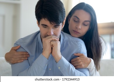 Head Shot Compassionate Young Woman Giving Psychological Support Help To Thoughtful Stressed Beloved Man In Hard Life Situation, Showing Love Care, Overcoming Grief Together Or Apologizing Indoors.