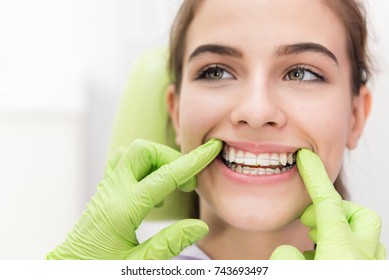 Head Shot Of Girl In Dentist Office. Orthodontic Brace Control, Unrecognizable Dentist