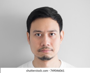 Head Shot Of Grumpy Face Asian Man.