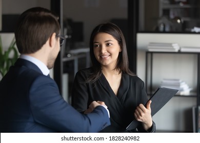 Head Shot Happy Young Male Executive Manager Leader Shaking Hands With Indian Ethnicity Female Employee, Praising For Good Job, Thanking For Excellent Project Results Or Professional Consultation.