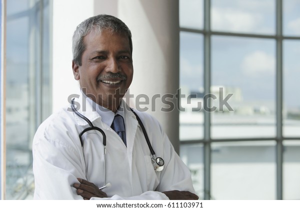Head shot of Indian doctor\
smiling