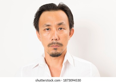 Head shot of middle aged Asian man looking at camera on white background. - Powered by Shutterstock