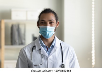 Head Shot Portrait African American Man Doctor Wearing Medical Mask And White Uniform, Confident Young Male Physician General Practitioner Looking At Camera, Healthcare And Coronavirus Concept