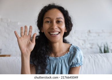 Head Shot Portrait African Woman Sit On Sofa Smile Looks At Camera Make Video Conference, Greets Friend, Talks To Family Living Abroad, Enjoy Remote Communication. Modern Tech, Videocall Event Concept