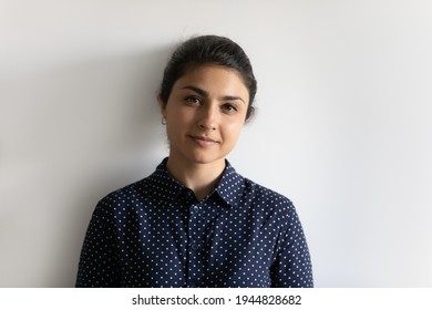 Head Shot Portrait Attractive Young Indian Woman Looking At Camera, Standing On White Wall Studio Background Isolated, Confident Millennial Businesswoman Or Student Posing For Photo, Profile Picture