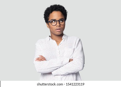 Head shot portrait close up annoyed African American woman in glasses rolling eyes, disappointed girl with arms crossed irritated by boring routine worker bad news, isolated on grey background - Powered by Shutterstock