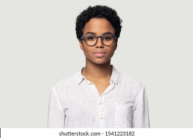 Head Shot Portrait Close Up Beautiful Young African American Woman In Glasses, Businesswoman, Student Wearing Shirt Looking At Camera, Girl With Perfect Skin, Isolated On Grey Background