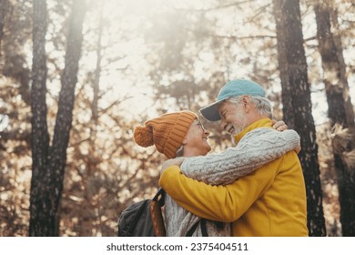 Head shot portrait close up of old people smiling and enjoying looking each other in the forest of mountain. Cute couple of mature seniors in love feeling happy and taking care. - Powered by Shutterstock