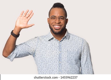 Head Shot Portrait Handsome African American Man In Glasses Looking At Camera, Happy Student Waving Hand In Greeting Gesture, Giving High Five To Friend, Isolated On White Studio Background