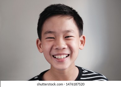 Head Shot Portrait Of Happy, Confident And Healthy Mixed Race Multiethnic Smiling Asian Preteen Teen Boy Face, Youth Day