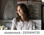 Head shot portrait happy young professional woman looking away with smile. Successful office employee feel satisfied with project accomplishment, promotion and career growth. Business vision, planning