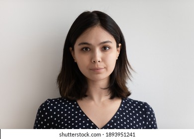 Head Shot Portrait Of Millennial Beautiful Asian Korean Mixed Race Woman Isolated On White Grey Studio Background, Happy Young Multiracial Lady Looking At Camera, Feeling Confident, Profile Photo.