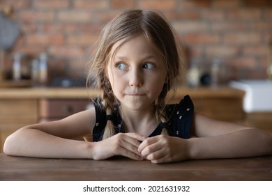 Head Shot Portrait Of Sly Little Girl With Guilty Scared Face And Shut Mouth. Funny Kid Looking Away, Keeping Silence About Tricks, Avoiding Punishment. Childhood, Young Age Problems Concept