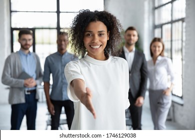 Head shot portrait smiling African American businesswoman offering handshake, standing with extended hand in modern office, friendly hr manager or team leader greeting or welcoming new worker - Shutterstock ID 1746129038
