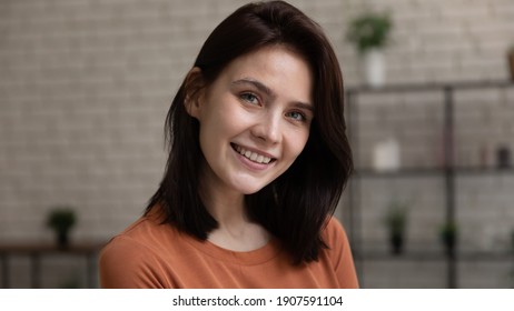 Head Shot Portrait Smiling Attractive Young Woman With Healthy Toothy Smile And Perfect Smooth Skin Looking At Camera, Beautiful Happy Female Standing At Home, Posing For Profile Picture