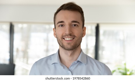Head shot portrait of smiling confident businessman looking at camera, successful executive employee intern posing for corporate photo, profile picture, coach mentor shooting webinar, recording video - Shutterstock ID 1978542860