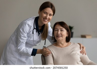 Head shot portrait smiling female therapist doctor in uniform with stethoscope touching mature patient shoulders, satisfied pleased client excited by good medical service in clinic, healthcare - Shutterstock ID 2074581250