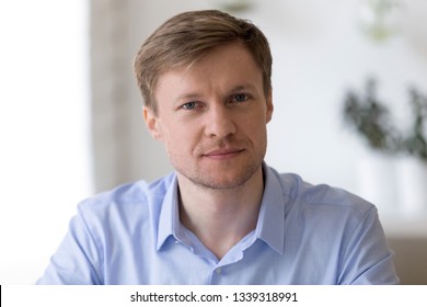 Head shot  portrait of smiling middle aged businessman sitting at work desk looking in camera Successful company executive manager posing at workplace, feeling confident and satisfied, profile picture - Shutterstock ID 1339318991