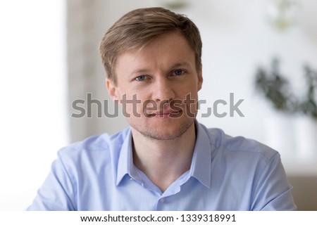 Head shot  portrait of smiling middle aged businessman sitting at work desk looking in camera Successful company executive manager posing at workplace, feeling confident and satisfied, profile picture