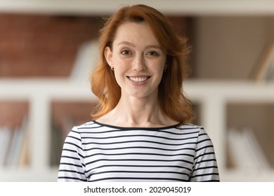 Head shot portrait of smiling professional female advisor, business trainer, businesslady coach looking at camera pose in office. New company employee photoshoot, hired worker profile picture concept