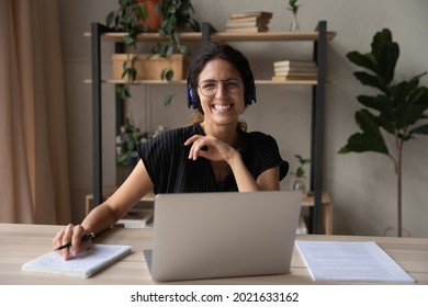 Head Shot Portrait Of Smiling Woman In Headphones Using Laptop, Looking At Camera, Businesswoman Consulting Client, Involved In Internet Meeting, Excited Student Studying Online, Watching Webinar