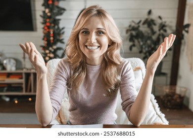 Head shot portrait smiling woman making video call to friends or relatives, using webcam, sitting on couch at home, happy young female blogger recording vlog, looking at camera, chatting online - Powered by Shutterstock