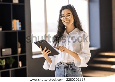 Head shot portrait smiling woman holding modern computer tablet in hands