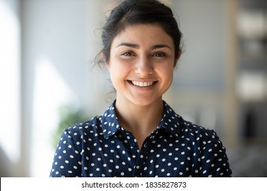 Head Shot Positive 25s Indian Female Smiling Looking At Camera. Successful Business Woman, Career Advance Of Worker, Happy Student Or Intern New Employee Portrait, Video Call Profile Picture Concept