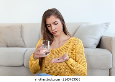 Head Shot Smiling Young Woman Holding Pill And Glass Of Fresh Pure Water. Healthy Millennial Lady Taking Antioxidant Medicine Vitamins, Beauty Supplements For Hair Skin Nails, Healthcare Concept.