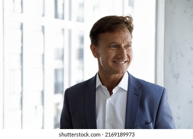 Head shot of successful middle-aged handsome businessman in elegant formal suit smile looks aside pose at modern skyscraper office. Executive manager, company owner or project leader portrait concept - Shutterstock ID 2169189973