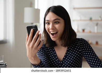 Head Shot Surprised Young Asian Vietnamese Woman Reading Message With Unexpected News, Happy Client Wins Online Shopping Promo Code Or Gets Prize In Social Network Giveaway, Good Luck Concept.