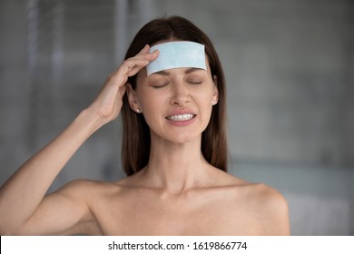 Head Shot Unhappy Close Up Woman Suffering From Headache With Closed Eyes, Touching Head, Stressed Young Female With Anti Migraine Cooling Path On Forehead, Health Problem, Pain Relief