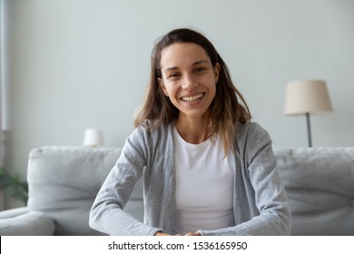 Head shot web camera view portrait happy smiling mixed race young woman sitting on couch in living room. Attractive positive female blogger recording video, communicating with friends or followers. - Shutterstock ID 1536165950