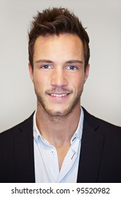 Head shot of young business man smiling