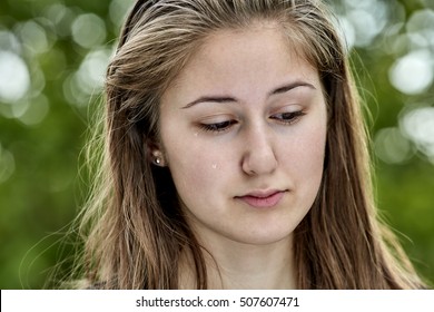 Head shot of young girl crying with tear drops