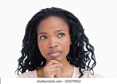 A Head Shot Of A Young Woman Who Is Thinking Against A White Background