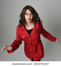 head and shoulders close up portrait of beautiful brunette woman model, wearing red trench coat jacket. isolated on white studio background, high angle perspective - Powered by Shutterstock